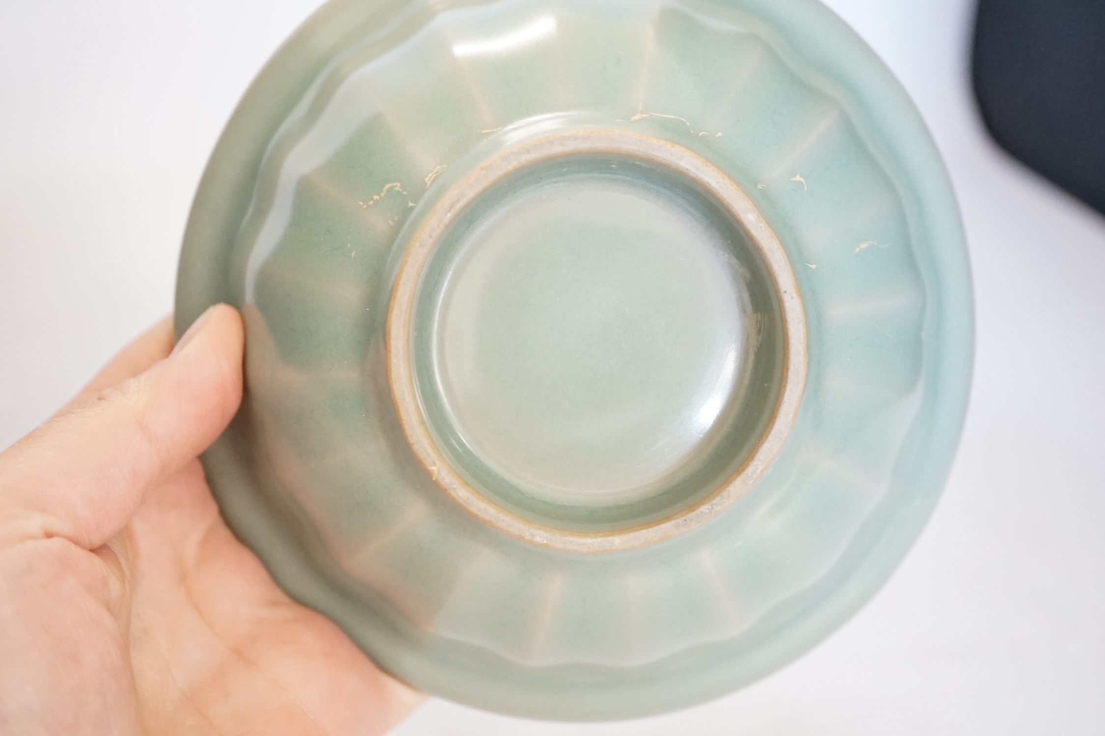A Chinese blue and white footed brushpot and celadon glazed ‘fish’ bowl, tallest 9cm. Condition - good